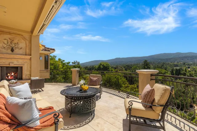 a view of a patio with couches chairs and a potted plant