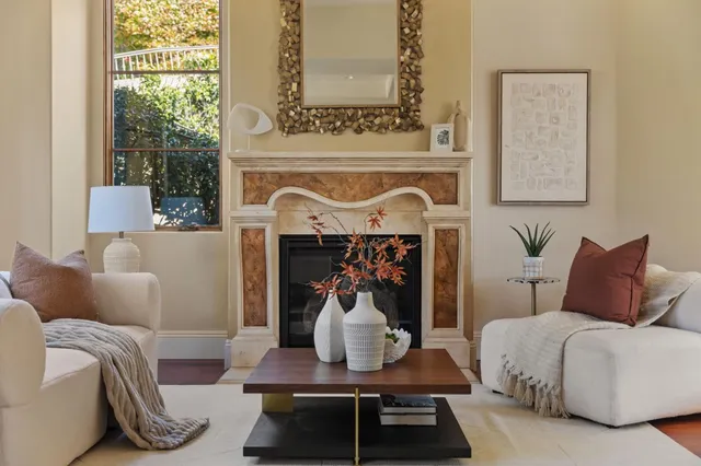 a living room with furniture a window and fireplace