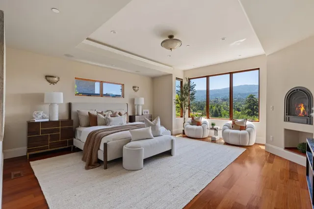 a bedroom with bed and large windows