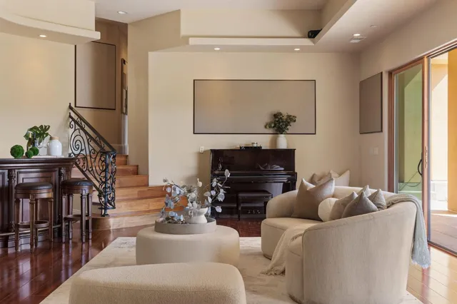 a living room with furniture a fireplace and a flat screen tv