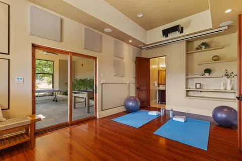 a living room with furniture a wooden floor and next to a window