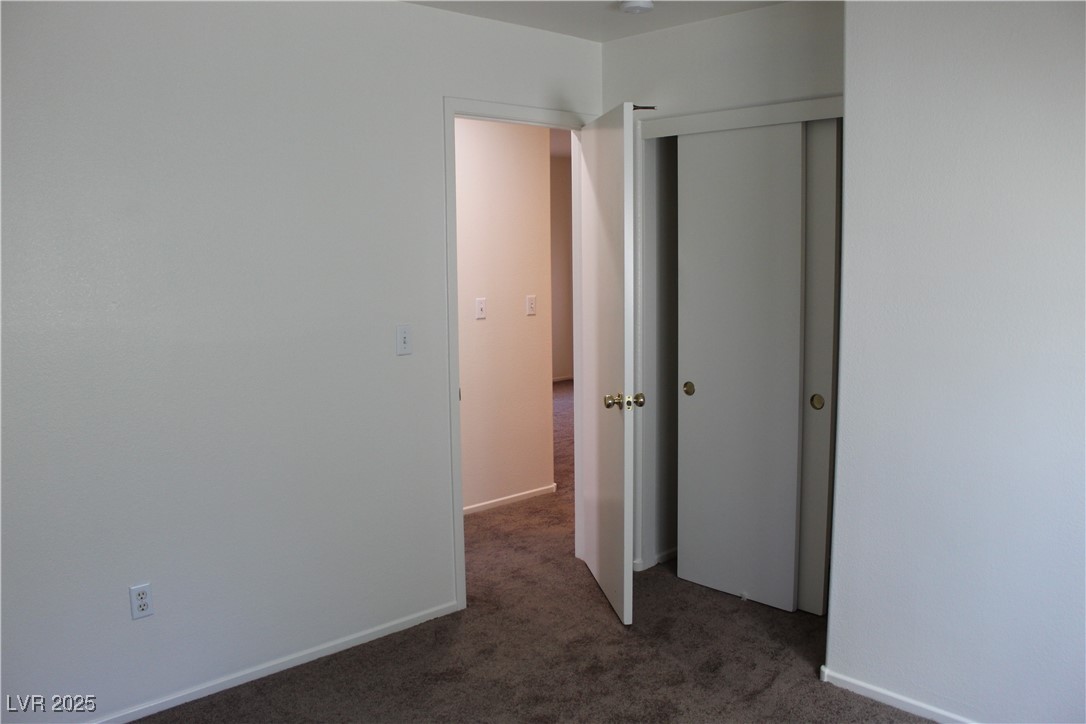 Undisclosed Address Las Vegas, NV 89129 - Photo 15 of 26 Unfurnished bedroom featuring a closet and carpet