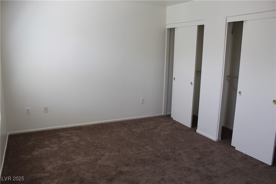 Undisclosed Address Las Vegas, NV 89129 - Photo 19 of 26 Unfurnished bedroom featuring multiple closets, ca
