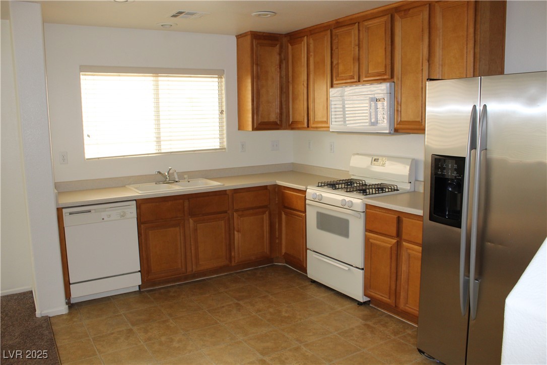 Undisclosed Address Las Vegas, NV 89129 - Photo 25 of 26 Kitchen with light countertops, visible vents, a s