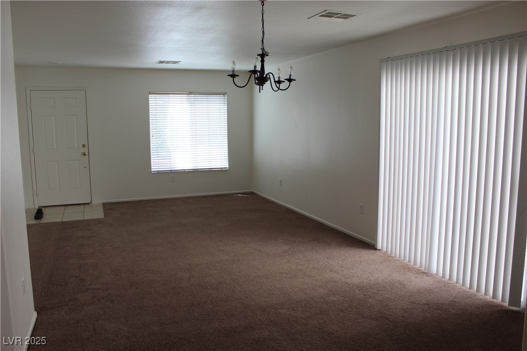Undisclosed Address Las Vegas, NV 89129 - Photo 3 of 26 Carpeted spare room featuring visible vents, baseb