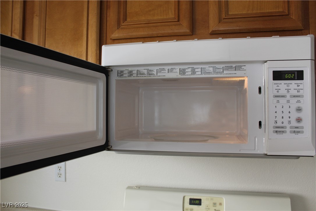 Undisclosed Address Las Vegas, NV 89129 - Photo 7 of 26 Details featuring white microwave and brown cabine