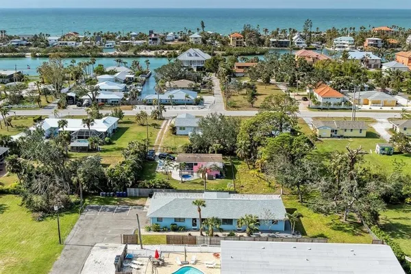 an aerial view of residential houses with outdoor space