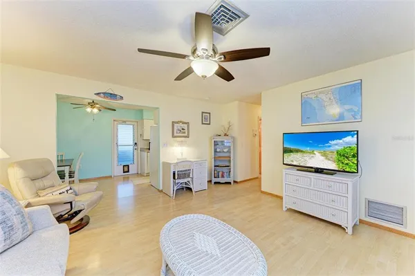 a bedroom with a bed window and a flat screen tv