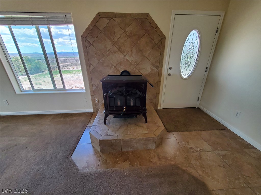 5272 Truman Lane Caliente, NV 89008 - Photo 7 of 43 Tiled foyer with a wood stove, baseboards, and healthy amount of natural light