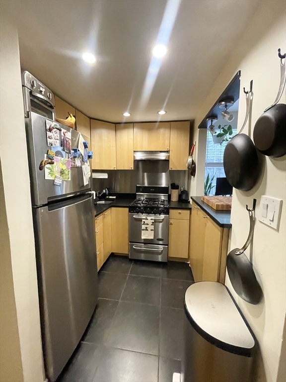 9 Primus Avenue, Unit 1 Boston, MA 02114 - Photo 16 of 19 a kitchen with stainless steel appliances a refrigerator and microwave