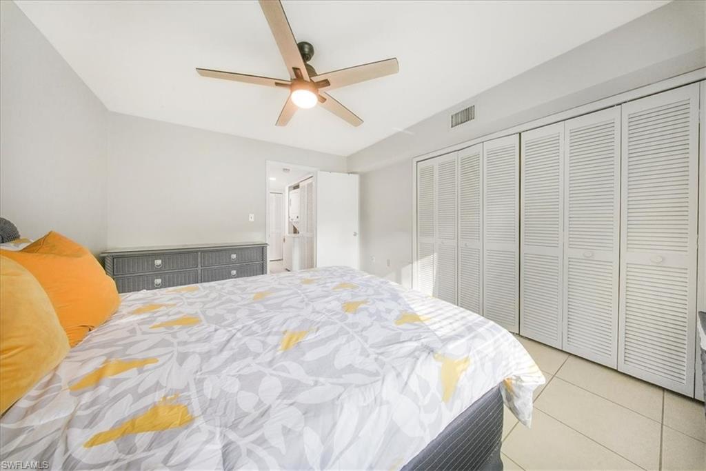 3170 Seasons Way, Unit 802 Estero, FL 33928 - Photo 20 of 31 a bedroom with a large bed and a chandelier