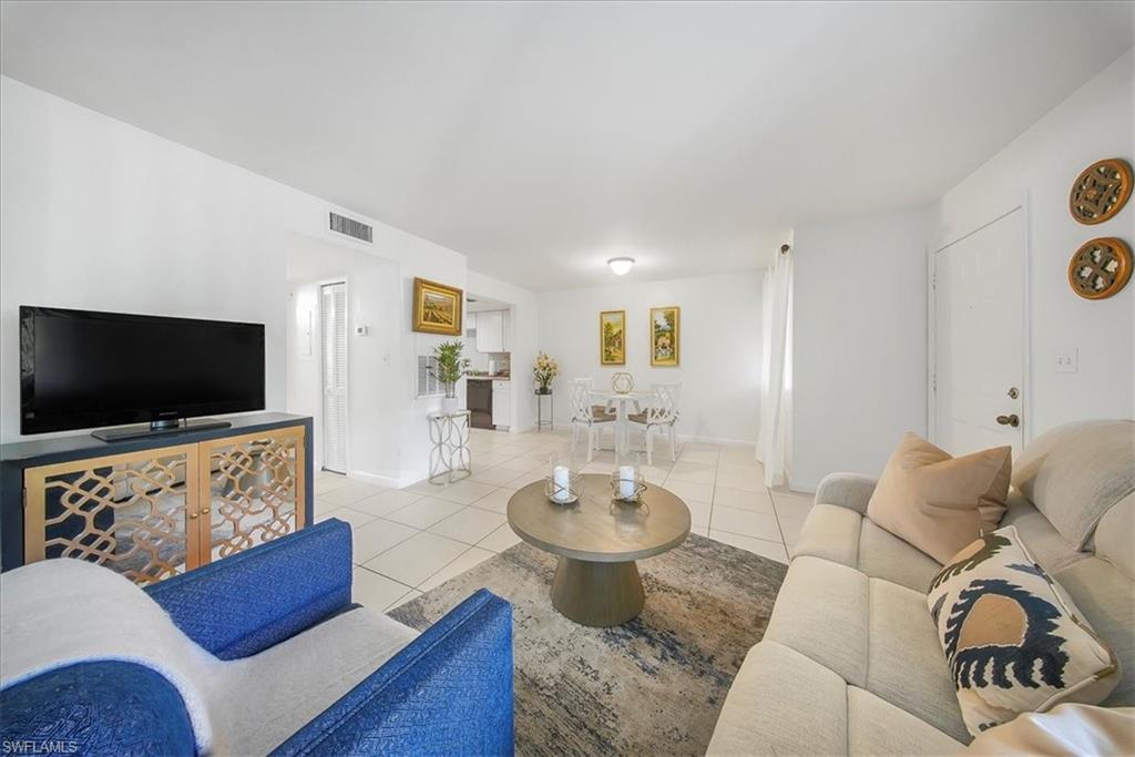 3170 Seasons Way, Unit 802 Estero, FL 33928 - Photo 8 of 31 a living room with furniture and a flat screen tv