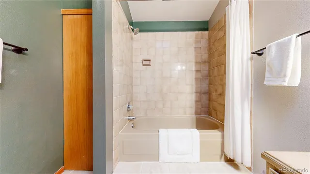 a bathroom with a shower and a bath tub