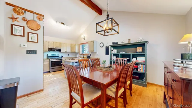 a dining room with stainless steel appliances kitchen island a table and chairs