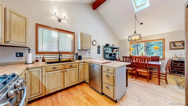 a kitchen with stainless steel appliances granite countertop sink stove top oven and cabinets