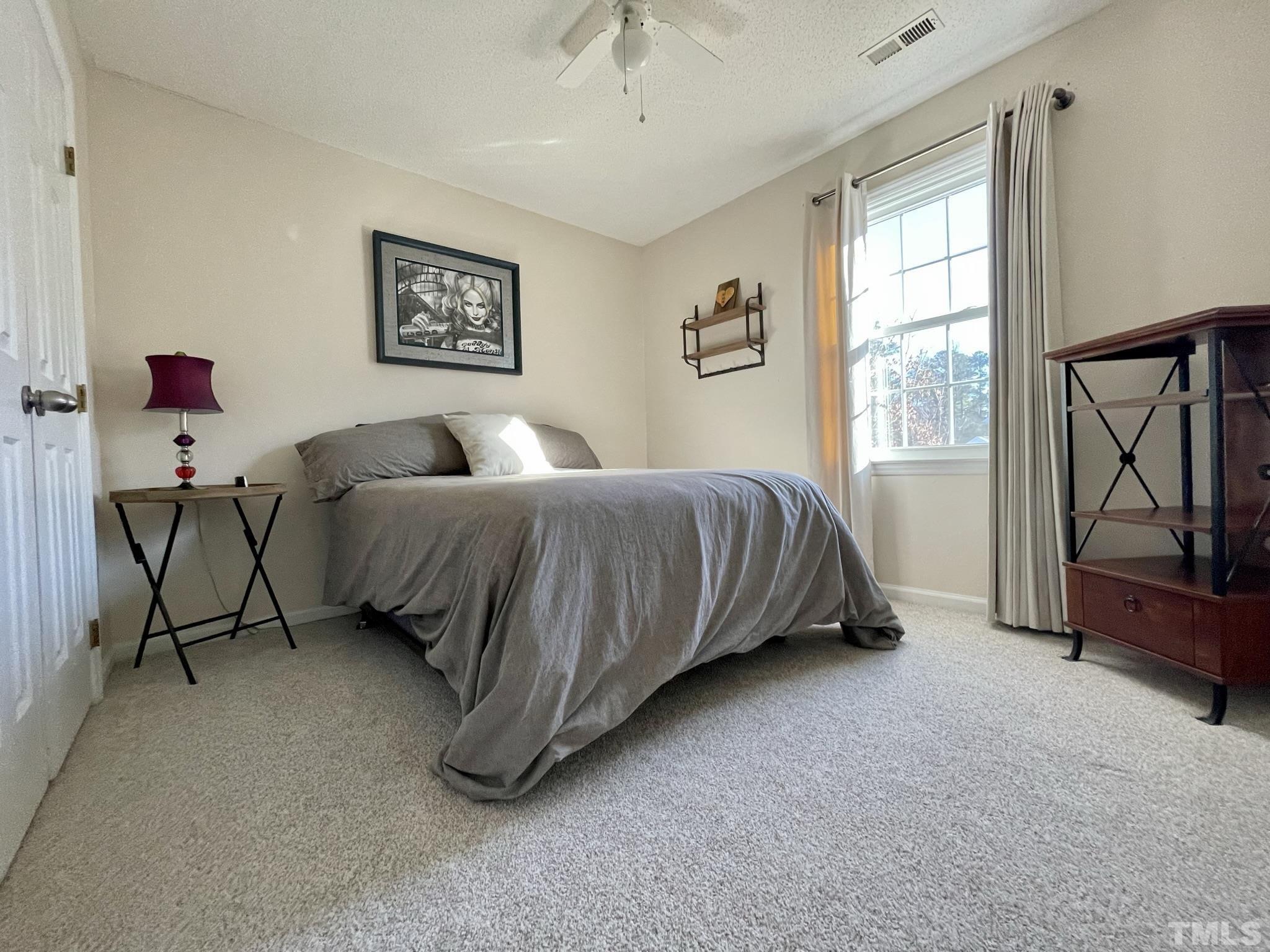 3924 Old Coach Road Raleigh, NC 27616 - Photo 6 of 24 a bedroom with a bed a couch and a window