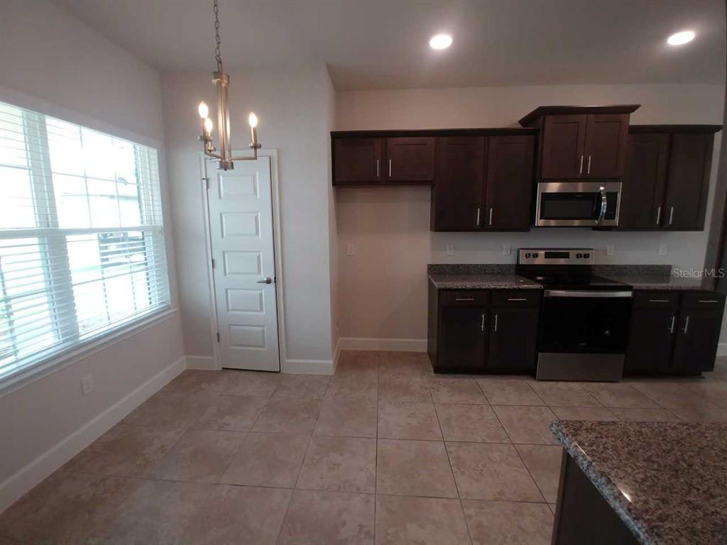 4380 Southwest 92nd Pl Road Ocala, FL 34476 - Photo 7 of 57 a kitchen with stainless steel appliances granite countertop a refrigerator and a sink