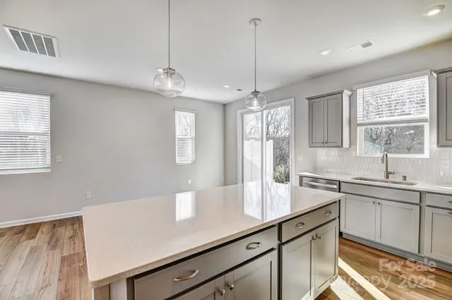 a view of a kitchen counter space a sink and appliances