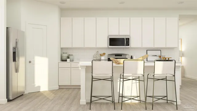 a kitchen with white cabinets and white appliances