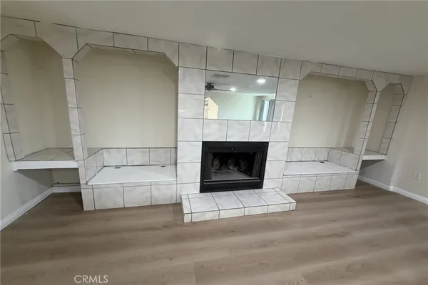 a living room with a fireplace and cabinets