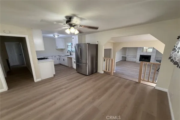 a kitchen with stainless steel appliances kitchen island granite countertop a refrigerator and a stove top oven