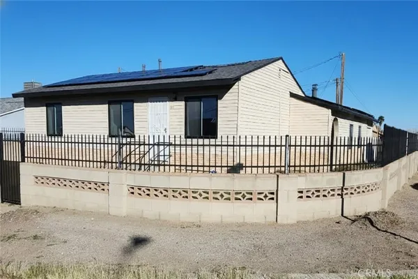 a view of a wooden house with a wooden fence