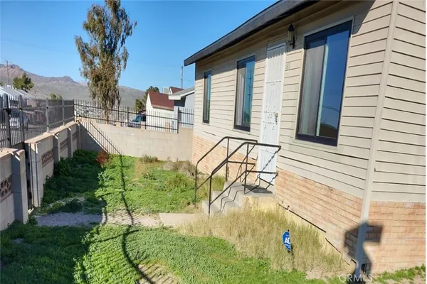a view of roof deck with couches and wooden fence