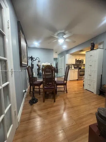 a living room with furniture a wooden floor and a chandelier