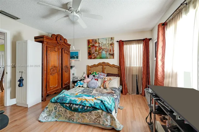 a bedroom with furniture and a window