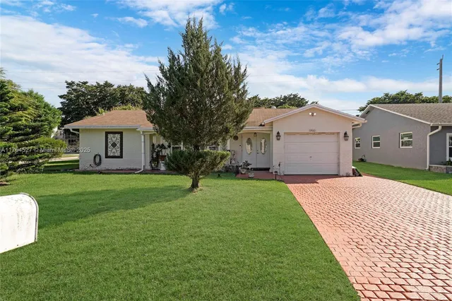 an aerial view of residential building with green space