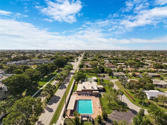 a view of a swimming pool with a yard