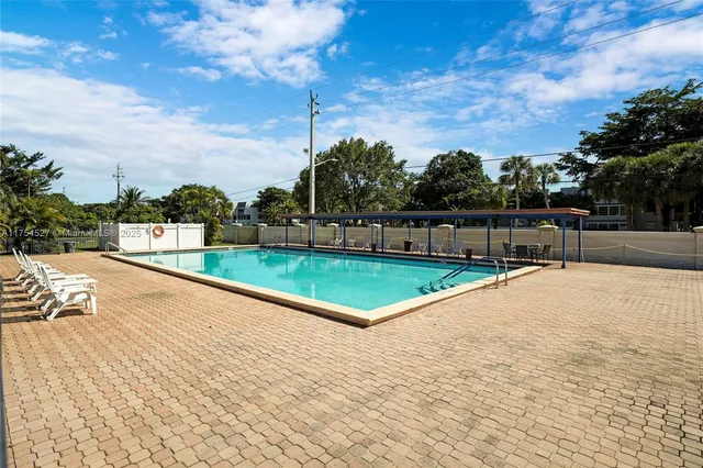 a front view of a house with a garden and yard