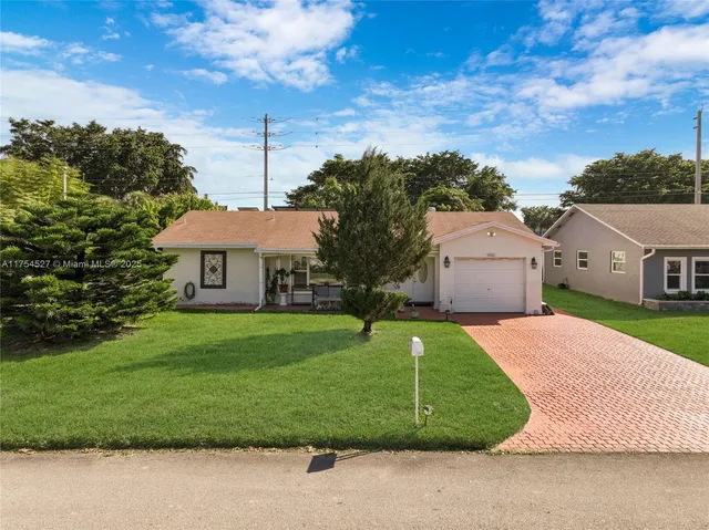 a sign that is sitting in front of flowers
