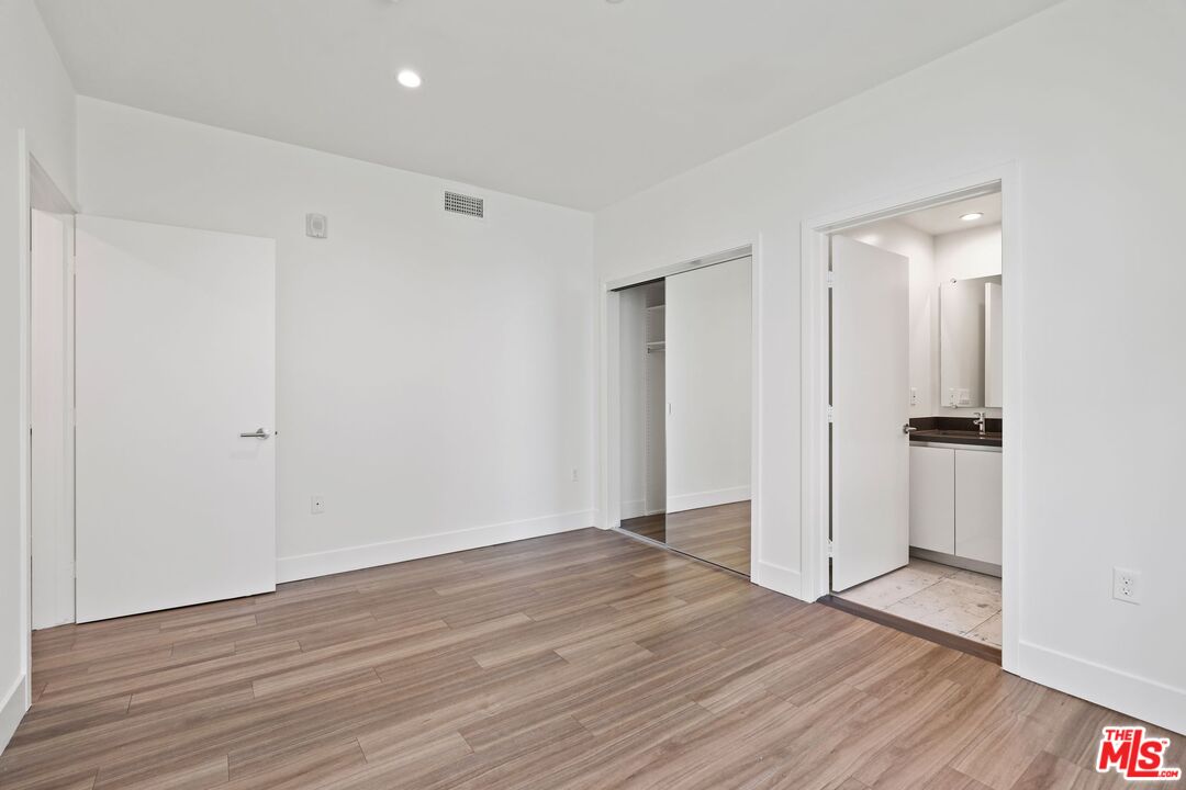 11847 Kiowa Avenue, Unit PH6 Los Angeles, CA 90049 - Photo 12 of 18 a view of an empty room with wooden floor