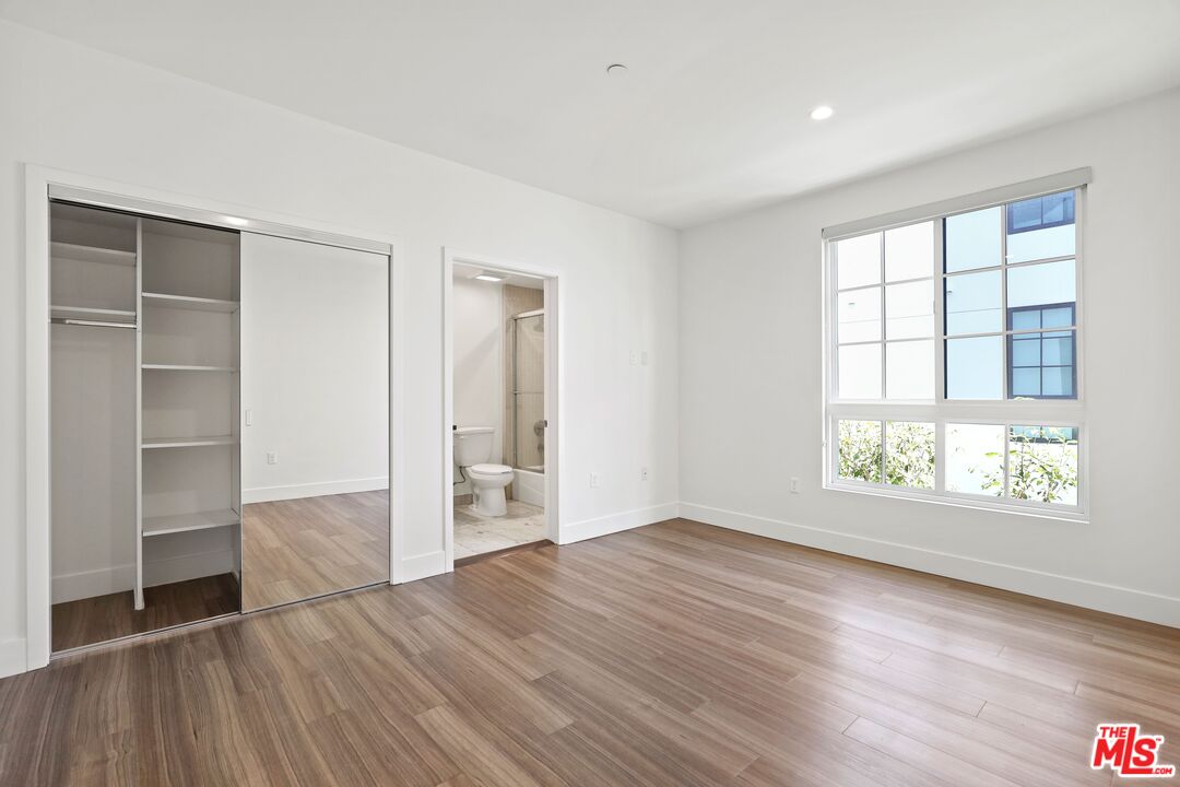 11847 Kiowa Avenue, Unit PH6 Los Angeles, CA 90049 - Photo 13 of 18 wooden floor in an empty room with a window