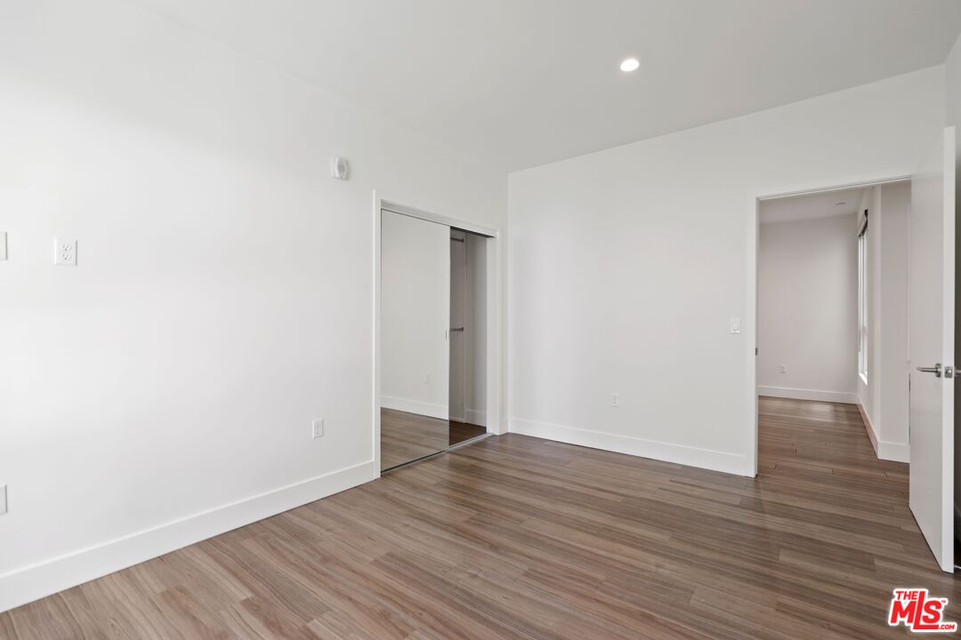 11847 Kiowa Avenue, Unit PH6 Los Angeles, CA 90049 - Photo 14 of 18 a view of an empty room with wooden floor