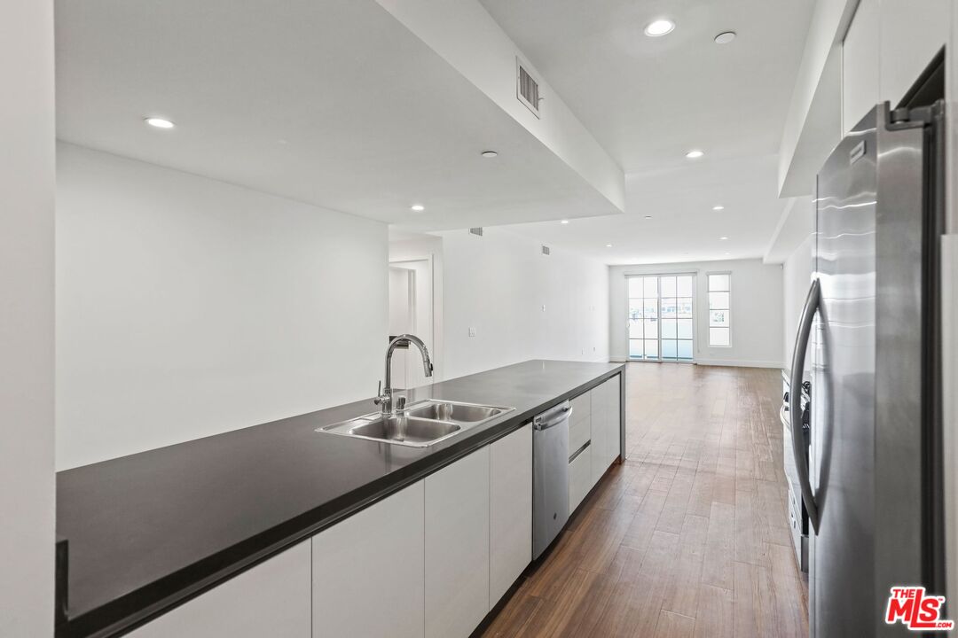 11847 Kiowa Avenue, Unit PH6 Los Angeles, CA 90049 - Photo 4 of 18 a kitchen with stainless steel appliances granite countertop a sink and a refrigerator