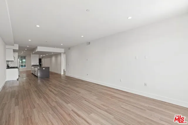 a view of kitchen and hall with wooden floor