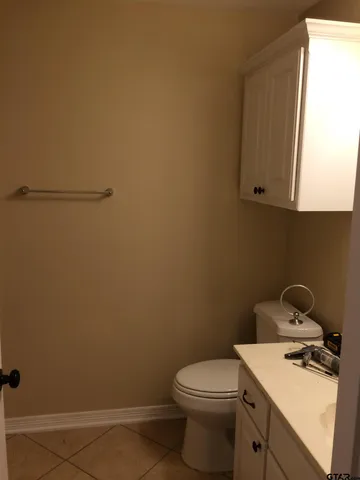 a bathroom with a toilet sink and vanity