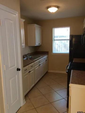 a kitchen with a stove a sink and a refrigerator