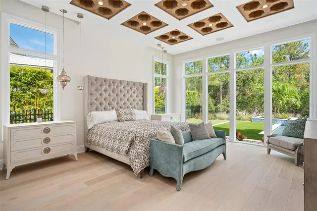 a bathroom with a granite countertop tub shower and mirror