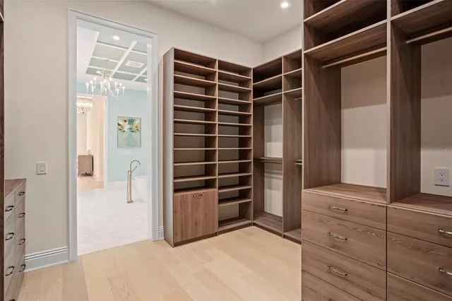 a living room with furniture a rug and a chandelier