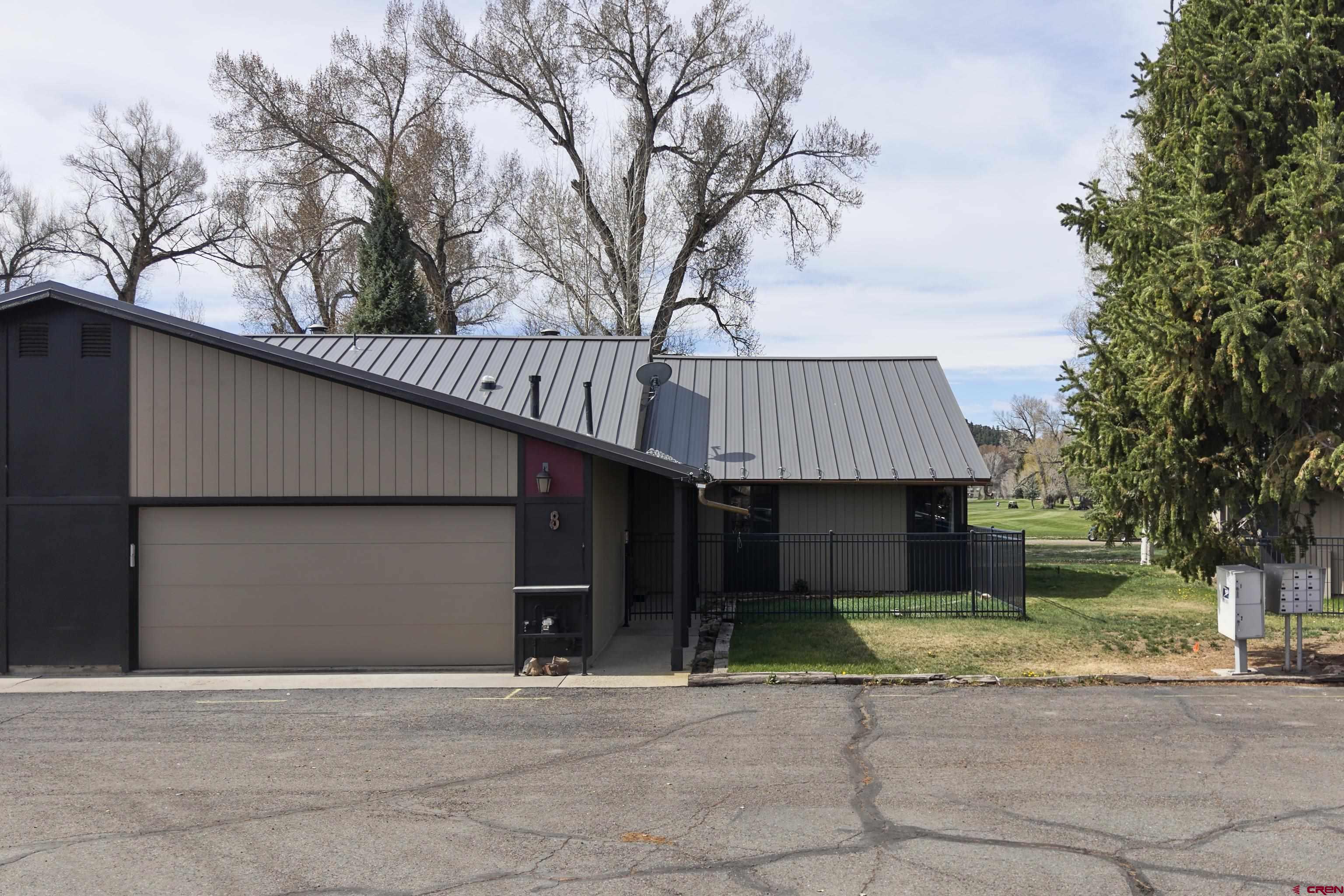 169 Camino Del Rio, Unit 8 Gunnison, CO 81230 - Photo 3 of 45 a front view of a house with garden