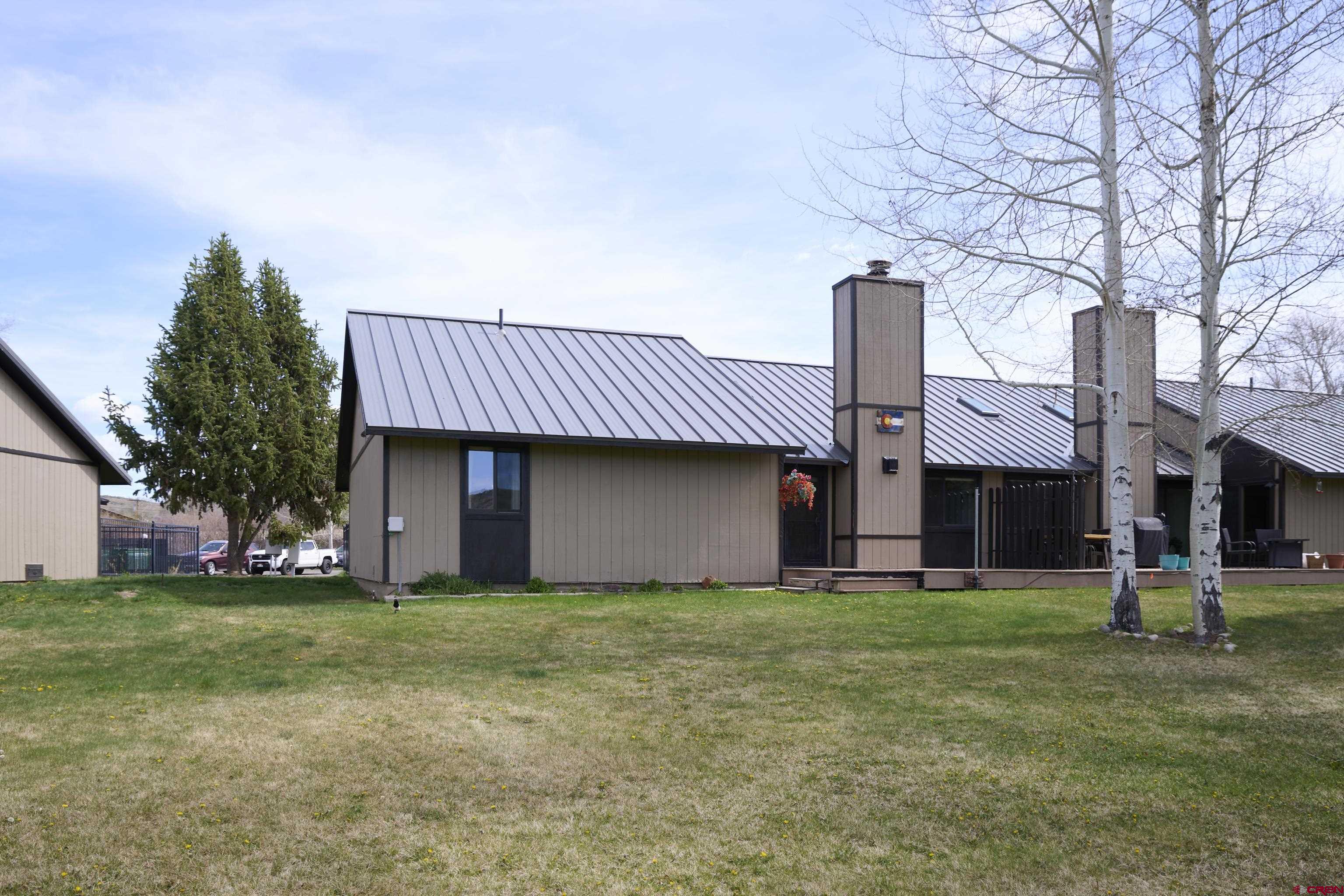 169 Camino Del Rio, Unit 8 Gunnison, CO 81230 - Photo 42 of 45 a view of a house with a yard