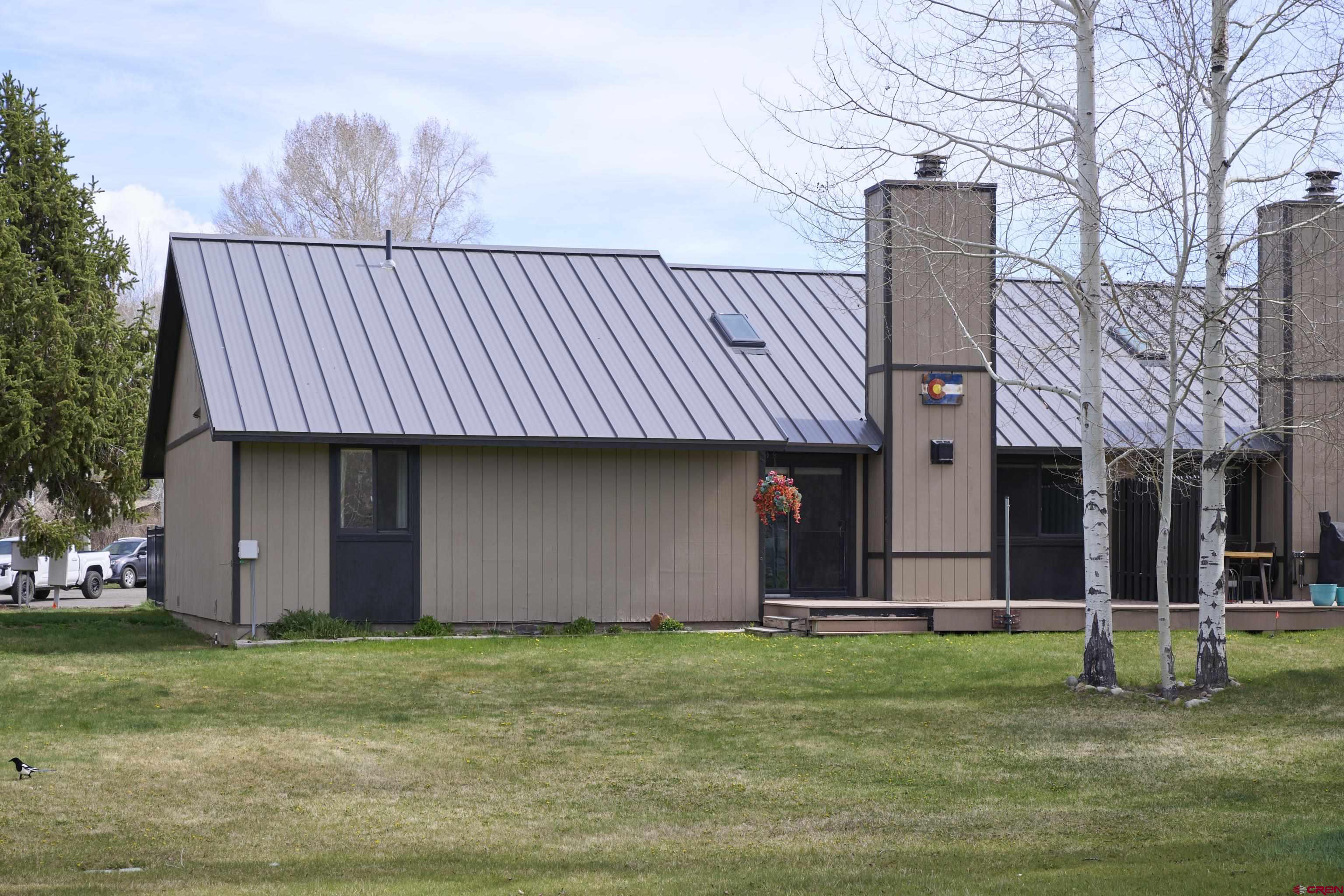 169 Camino Del Rio, Unit 8 Gunnison, CO 81230 - Photo 43 of 45 a backyard of a house with lots of green space