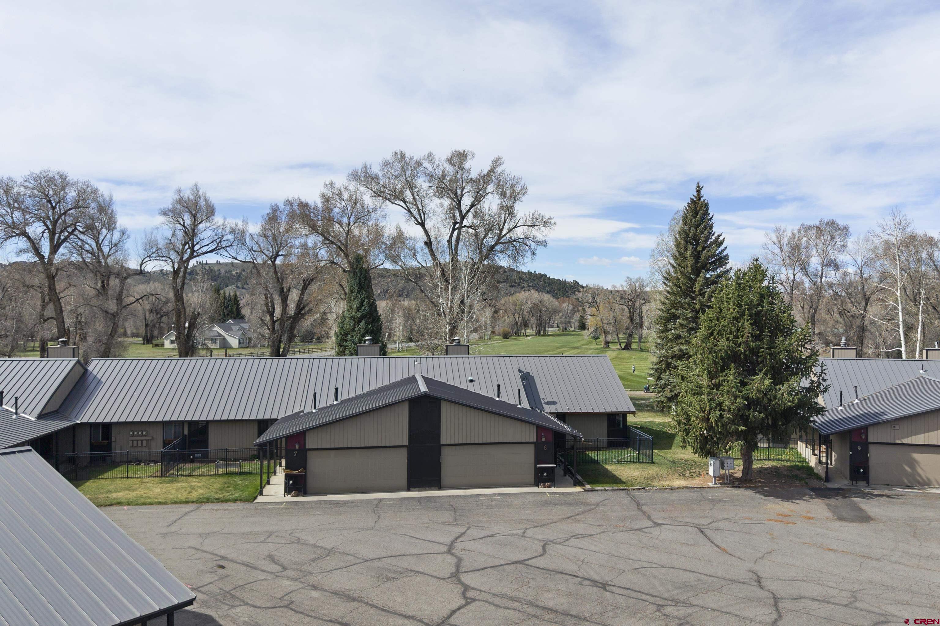 169 Camino Del Rio, Unit 8 Gunnison, CO 81230 - Photo 8 of 45 a view of house and outdoor space with swimming pool and yard