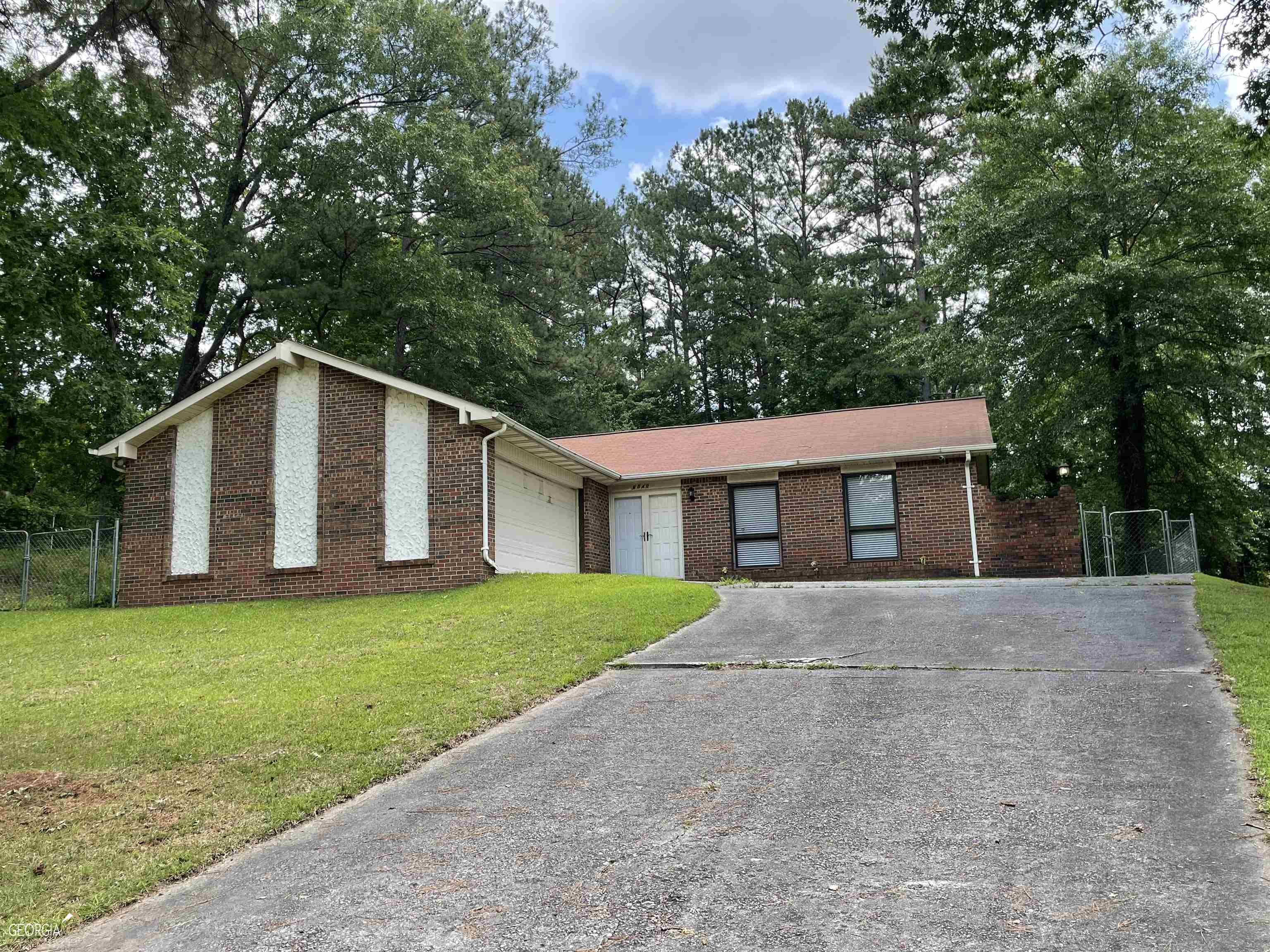 6540 Bellburn Road South Fulton, GA 30349 - Photo 1 of 1 a view of a yard in front of a house with large trees