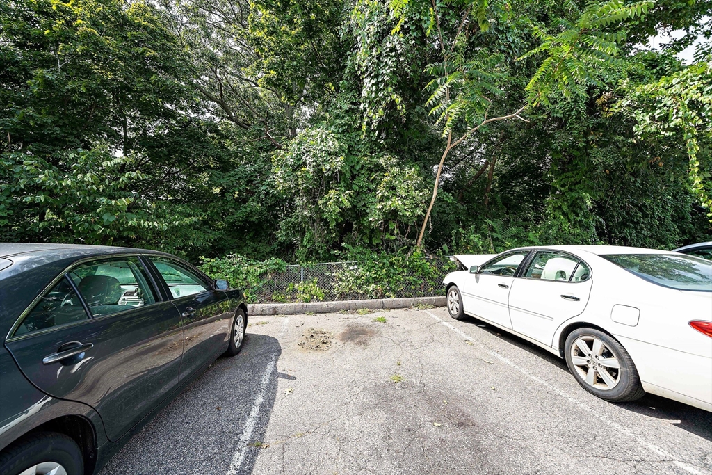 383 Langley Road, Unit 11 Newton, MA 02459 - Photo 15 of 15 a view of a car parked in a parking space