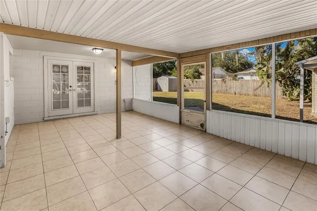 a view of a patio with table and chairs with wooden fence