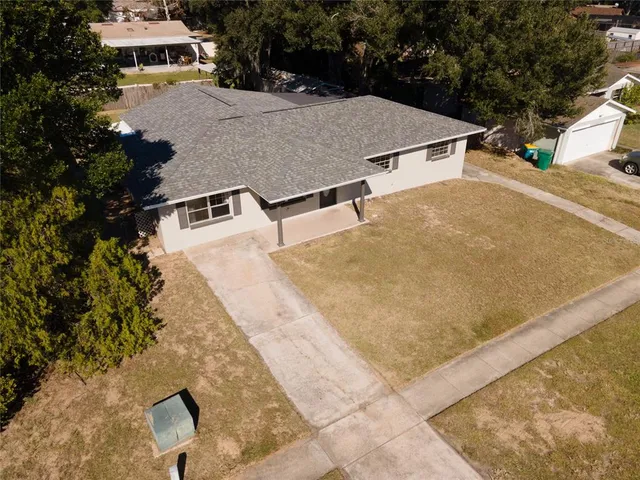 an aerial view of a house with a yard